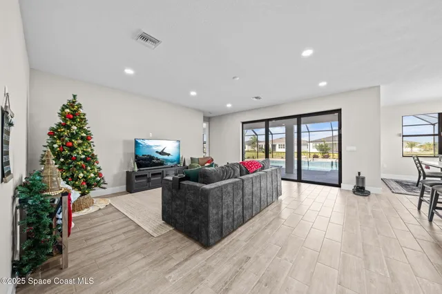 a living room with furniture potted plant and a window