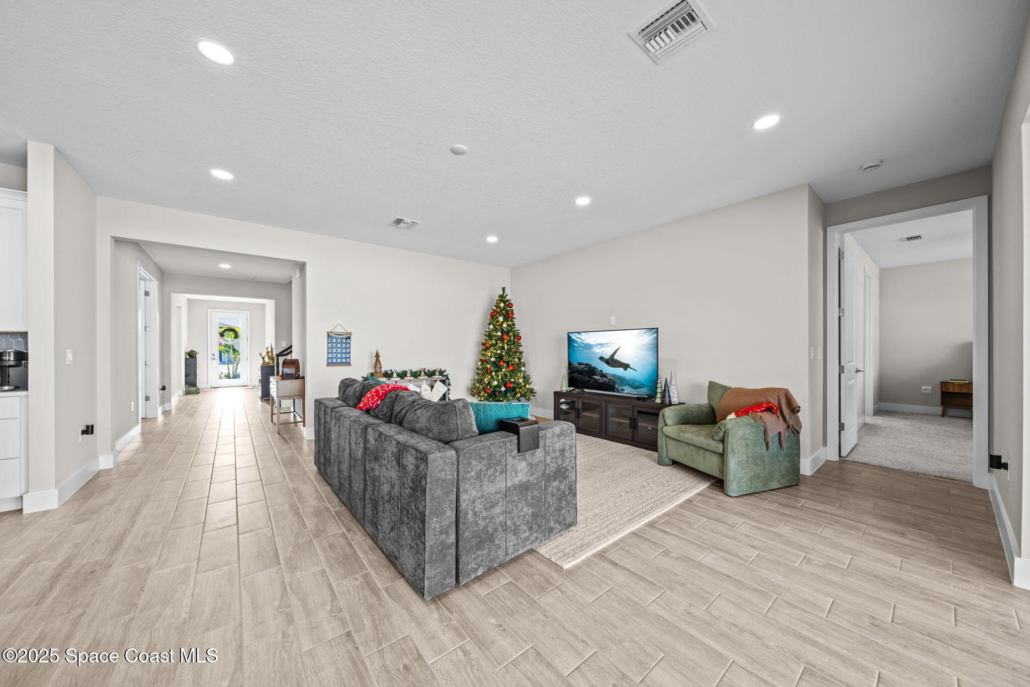 2846 Silverlefe Lane Melbourne, FL 32940 - Photo 10 of 58 a living room with furniture and a flat screen tv