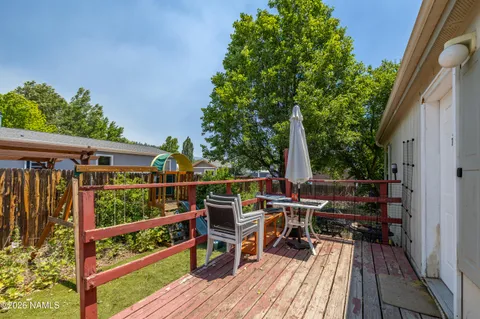 a view of deck with furniture and trees