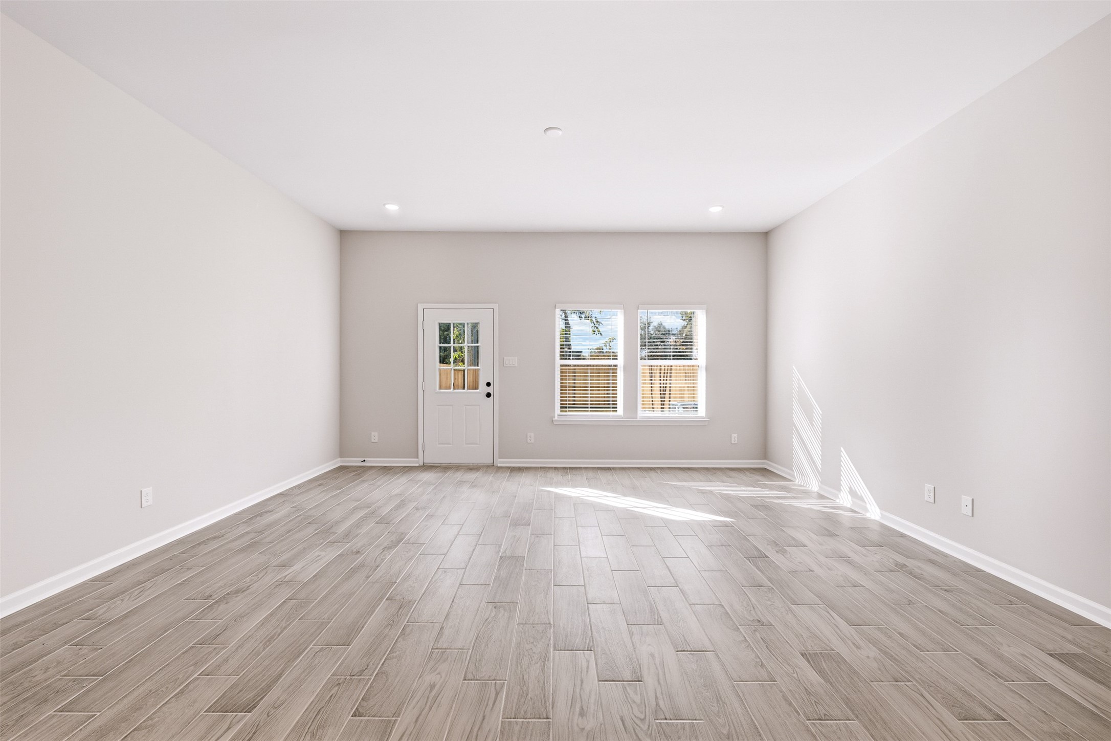 6111 Haight Street Houston, TX 77028 - Photo 6 of 21 an empty room with wooden floor and windows