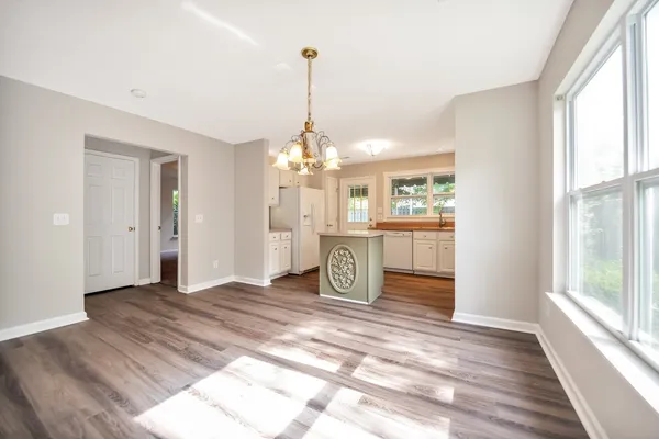 a view of a livingroom with a window and wooden floor