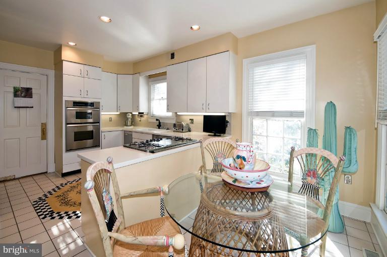 1626 Foxhall Road Northwest Washington, DC 20007 - Photo 11 of 21 a kitchen with stainless steel appliances granite countertop a stove a sink a dining table and chairs