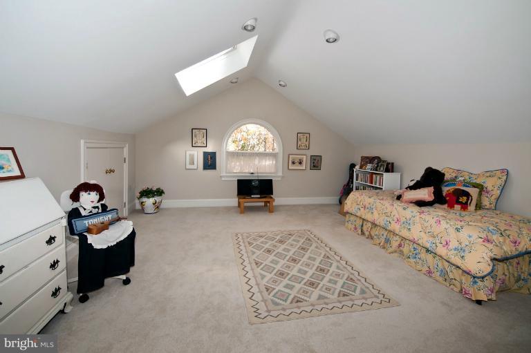 1626 Foxhall Road Northwest Washington, DC 20007 - Photo 10 of 21 a bed room with furniture and a chandelier