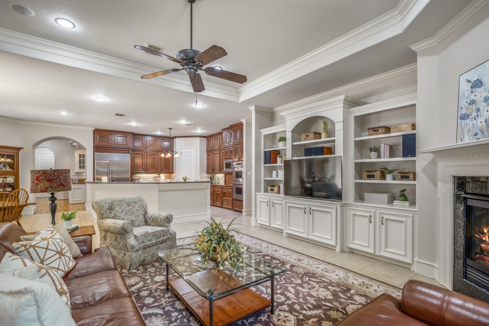 8806 Sterling Gate Circle Spring, TX 77379 - Photo 17 of 40 This view of the den shows the built in shelves with the kitchen in view.