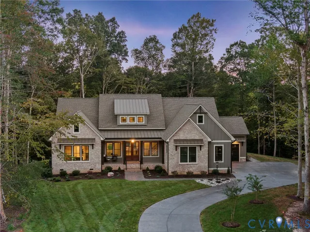 a view of a big house with a big yard and large trees