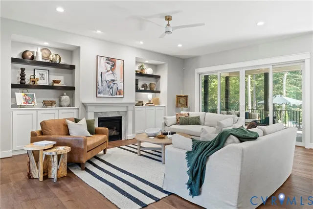 a living room with furniture fireplace and a large window