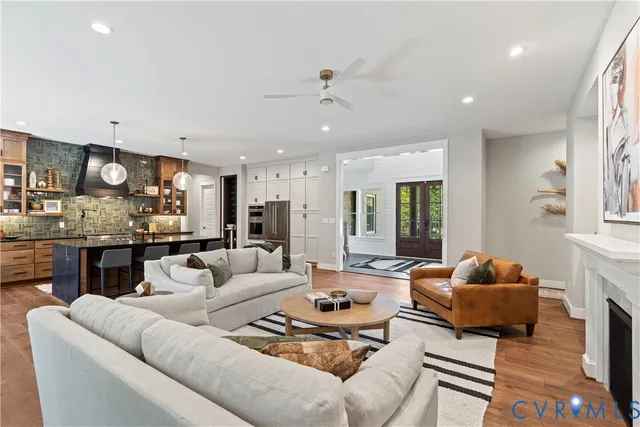 a living room with furniture and kitchen view