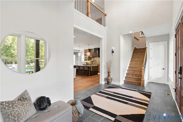 a bedroom with wooden floor and a large window