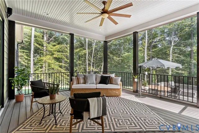 a living room with furniture and a floor to ceiling window