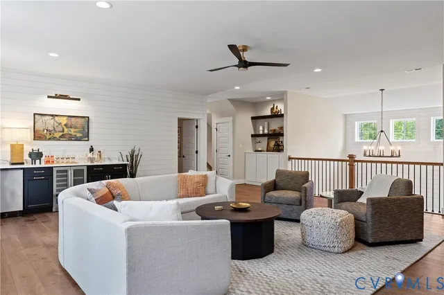 a living room with furniture and kitchen view