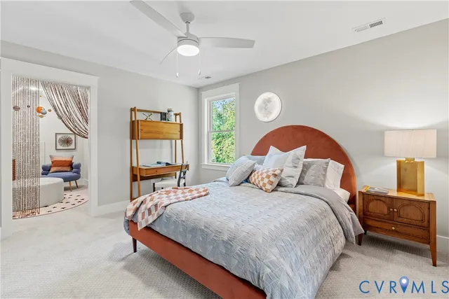 a bedroom with a bed and a painting on the wall