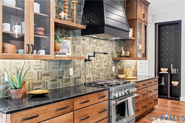 a kitchen with stainless steel appliances granite countertop a sink and wooden cabinets