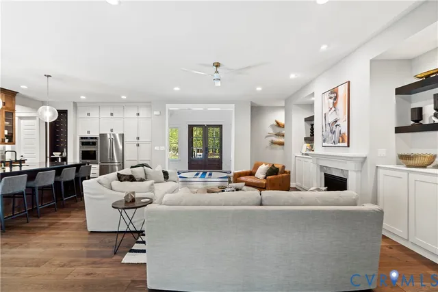 a living room with fireplace furniture and a flat screen tv
