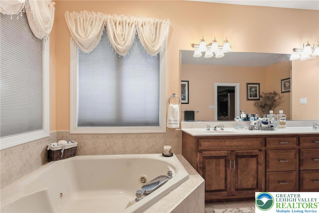 5217 Cider Press Road Schnecksville, PA 18078 - Photo 28 of 54 a bathroom with a tub sink and mirror