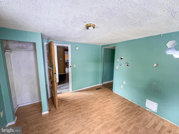 a view of a room with wooden floor
