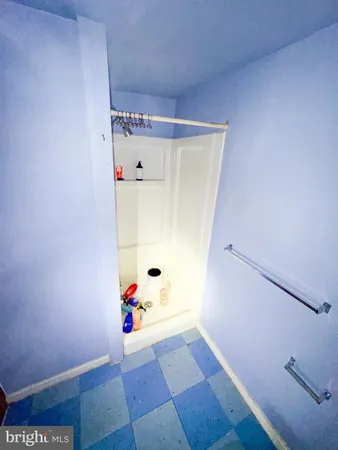 a view of a bedroom with a rug wooden floor and cabinet