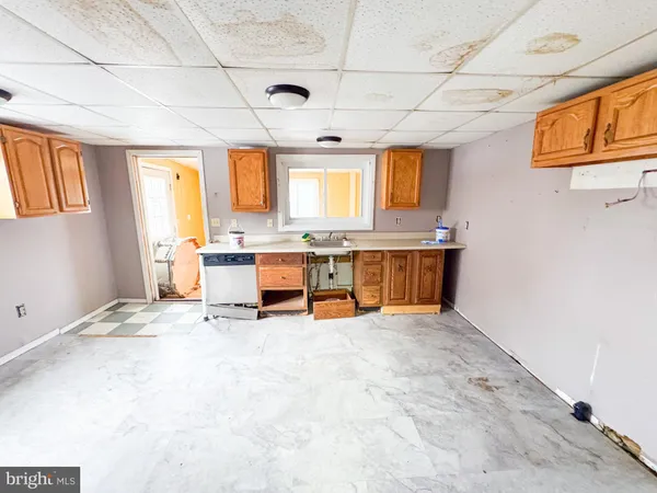 a view of a kitchen with stainless steel appliances granite countertop a sink and cabinets