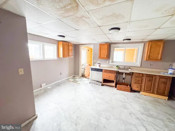 a large white kitchen with a large window