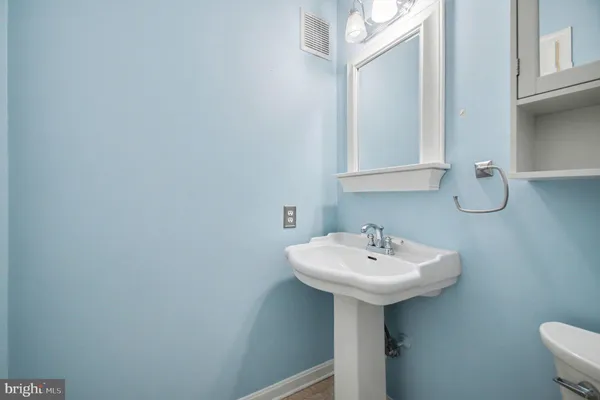 a bathroom with a sink a mirror and a toilet