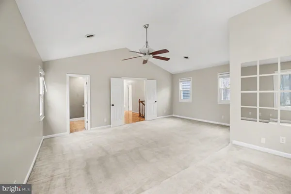 a view of a livingroom with a ceiling fan and window