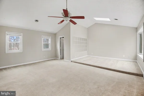 a view of a livingroom with a ceiling fan and window
