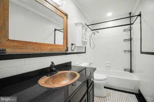 a bathroom with a sink a toilet and a bathtub