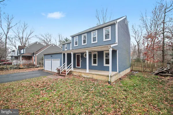 a view of house with yard and sitting area