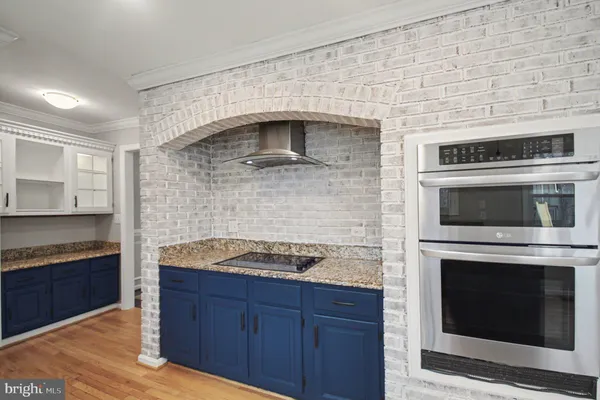 a kitchen with granite countertop stainless steel appliances a stove a microwave and a sink