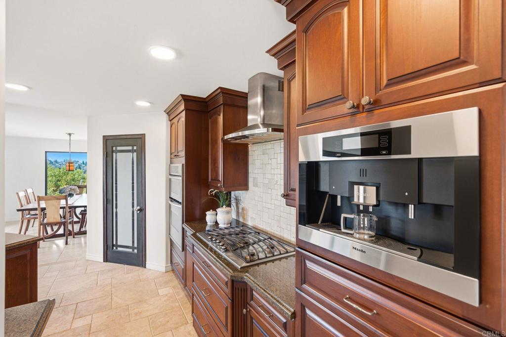 13319 Pacer Lane Poway, CA 92064 - Photo 12 of 75 a kitchen with stainless steel appliances granite countertop a stove and a refrigerator