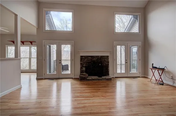 a living room with fireplace furniture and a wooden floor
