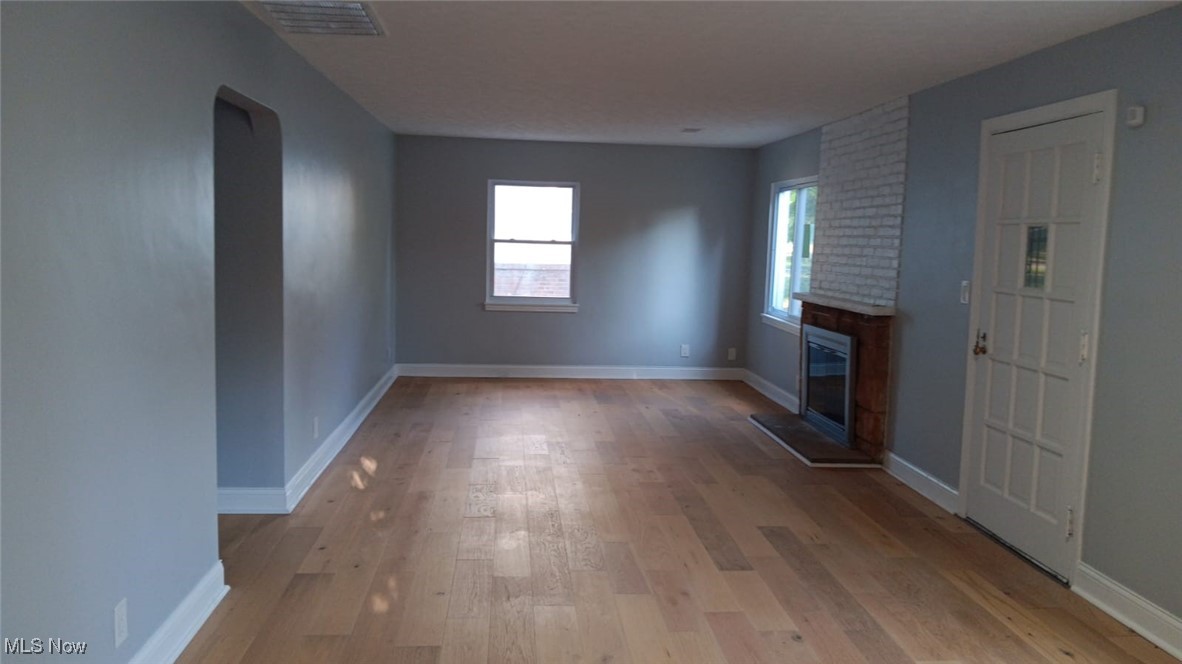 3999 Lancaster Road South Euclid, OH 44121 - Photo 13 of 17 Unfurnished living room with light wood-type flooring and a large fireplace