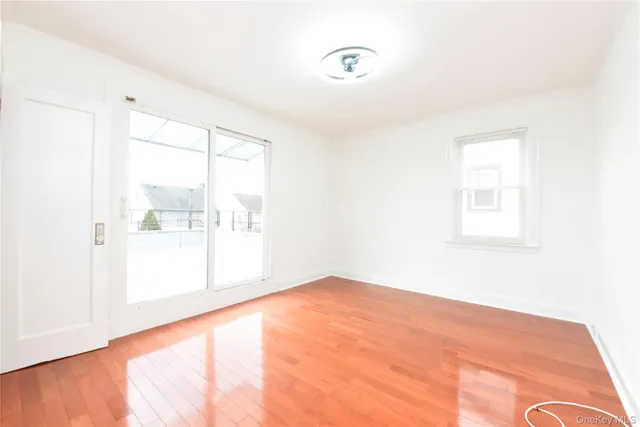 a bedroom with a bed window and flat screen tv