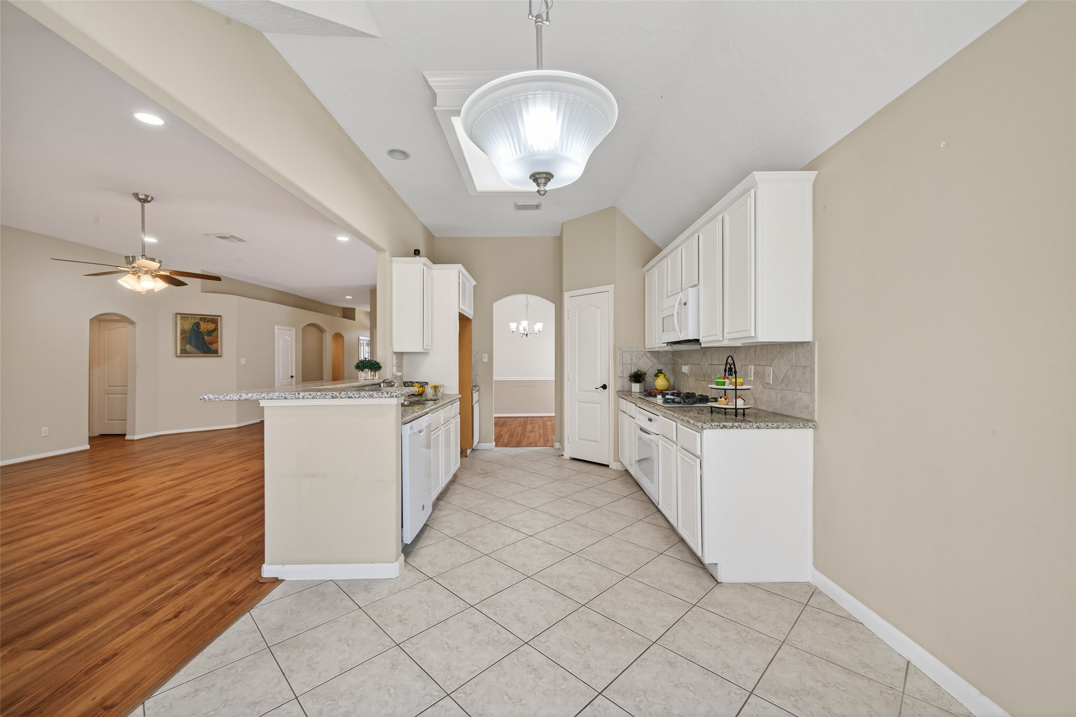 23211 Goldensong Court Spring, TX 77373 - Photo 15 of 46 a large white kitchen with cabinets a sink and dishwasher