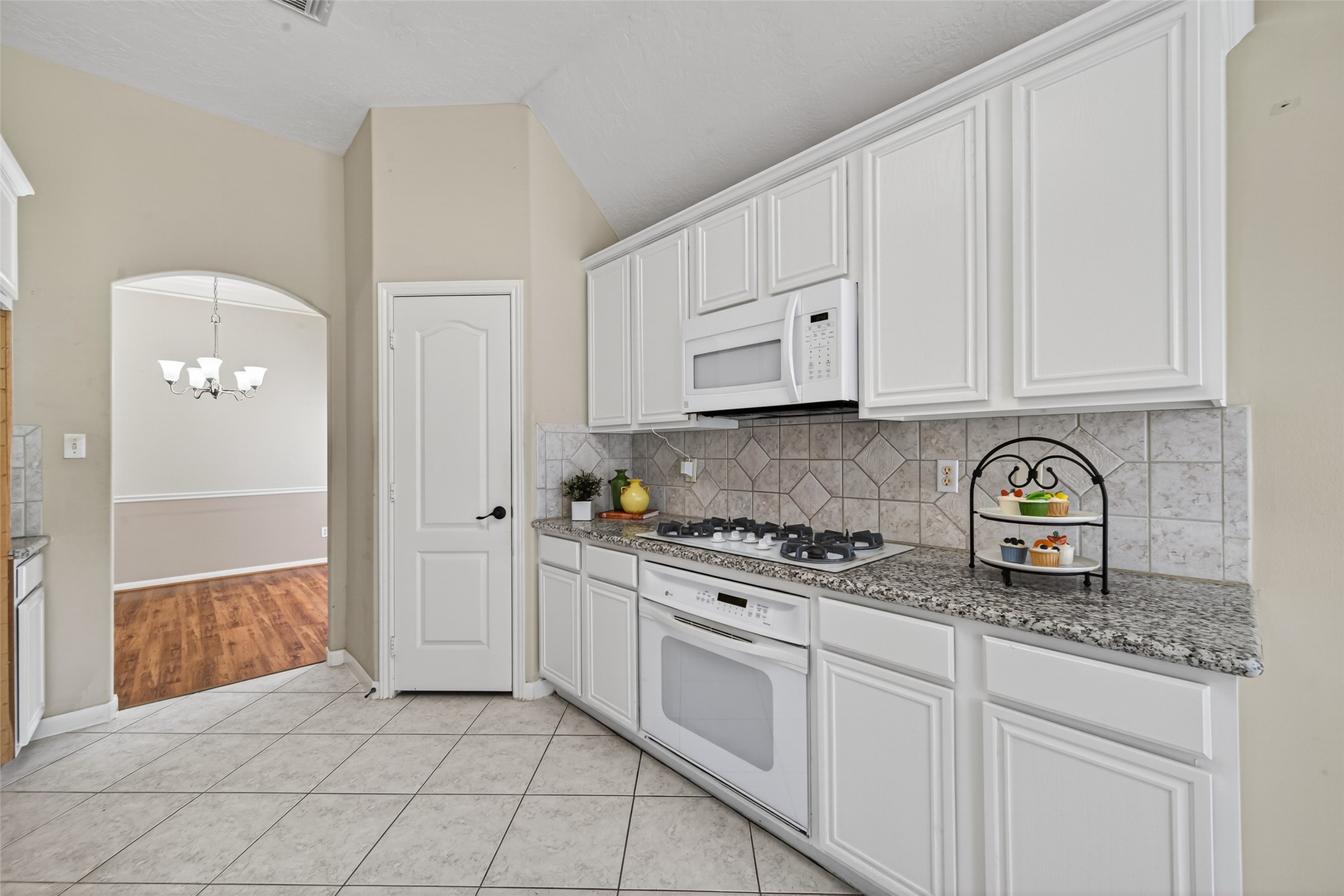 23211 Goldensong Court Spring, TX 77373 - Photo 19 of 46 a kitchen with stainless steel appliances granite countertop a sink and cabinets