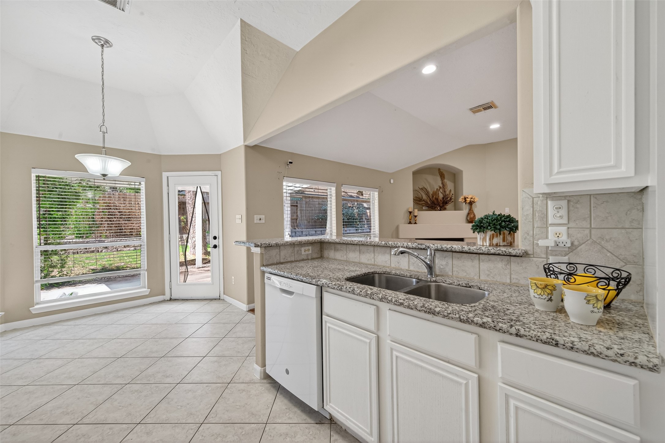 23211 Goldensong Court Spring, TX 77373 - Photo 24 of 46 a kitchen with a sink and cabinets