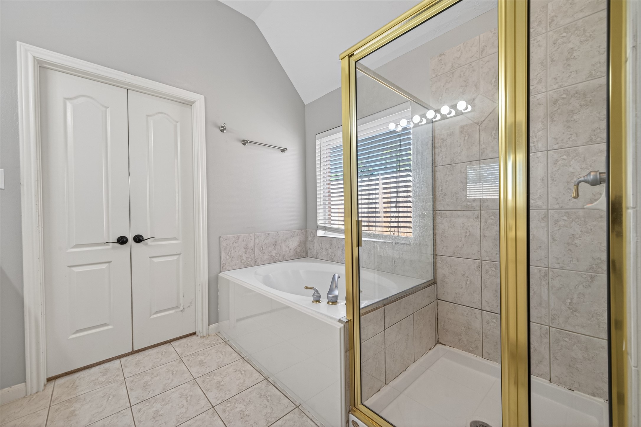 23211 Goldensong Court Spring, TX 77373 - Photo 34 of 46 a bathroom with a bathtub and a shower