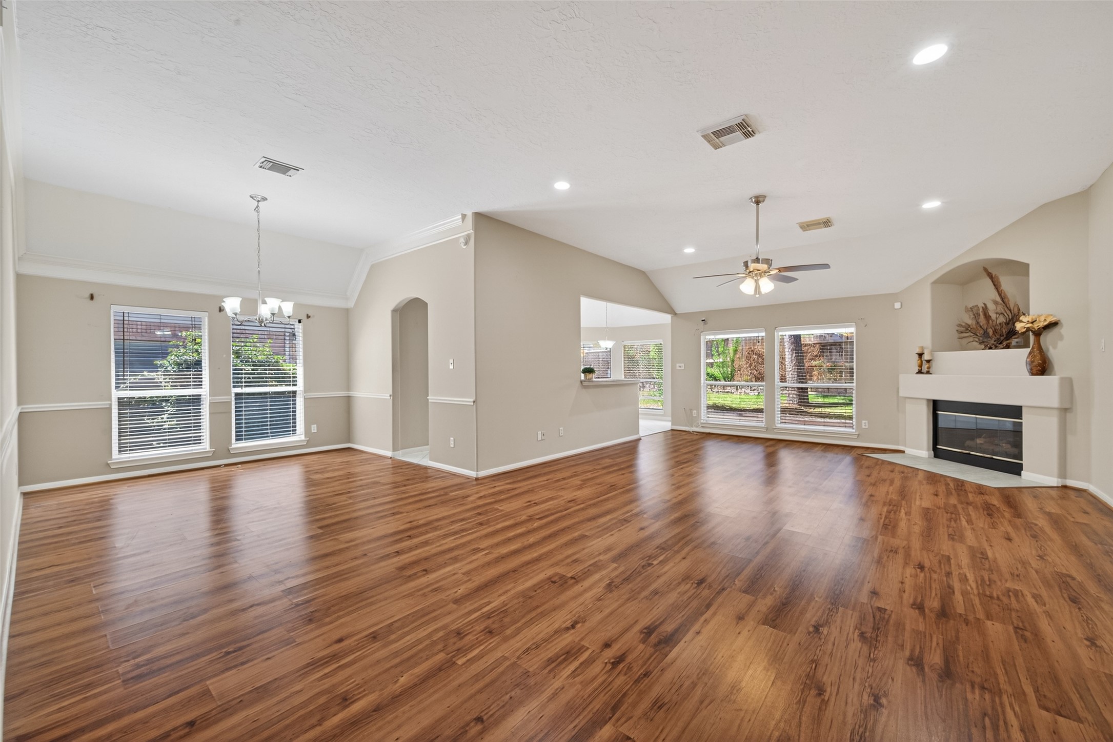 23211 Goldensong Court Spring, TX 77373 - Photo 6 of 46 an empty room with wooden floor fireplace and windows