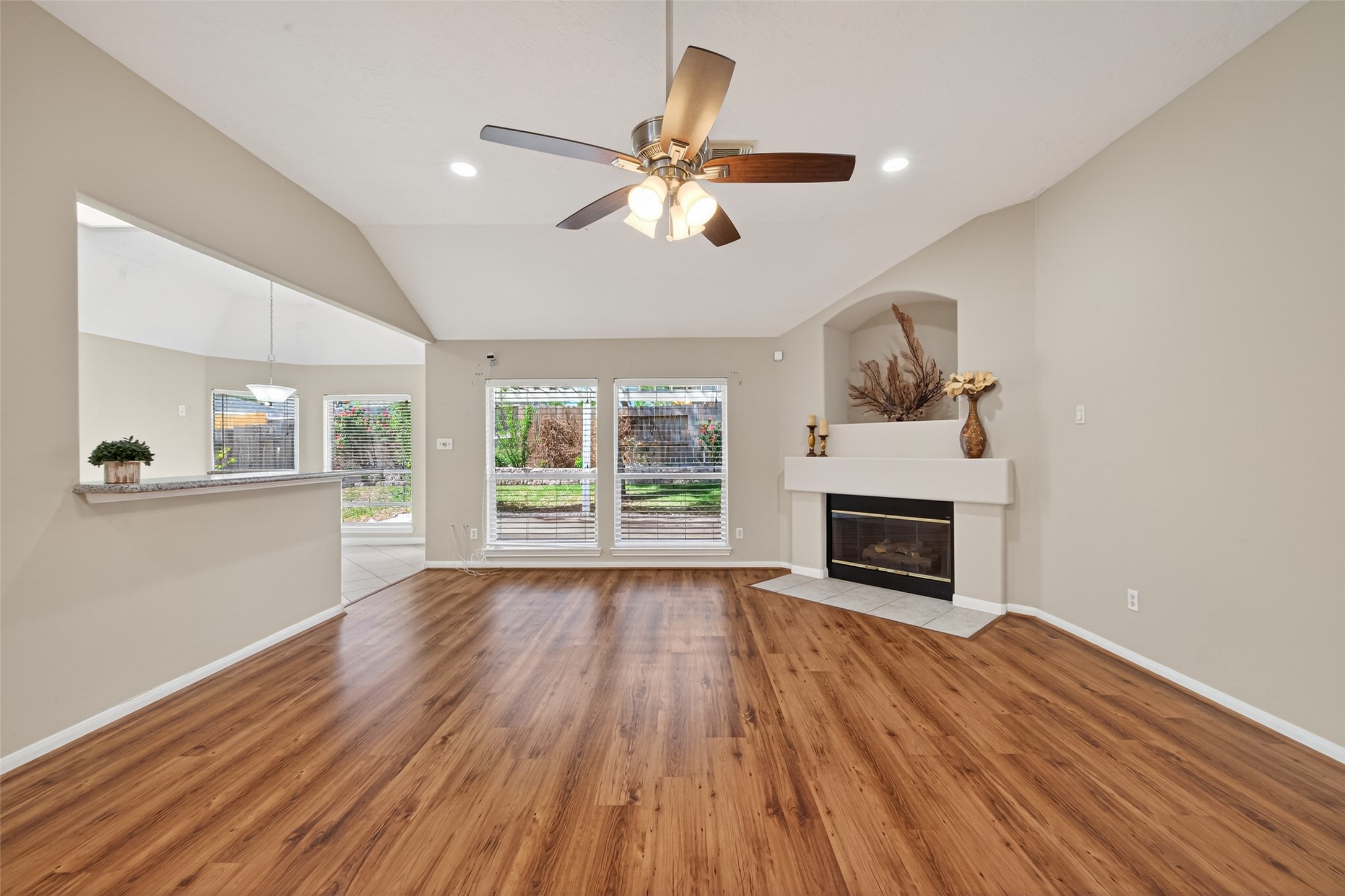 23211 Goldensong Court Spring, TX 77373 - Photo 8 of 46 a view of main area fire place window and wooden floor