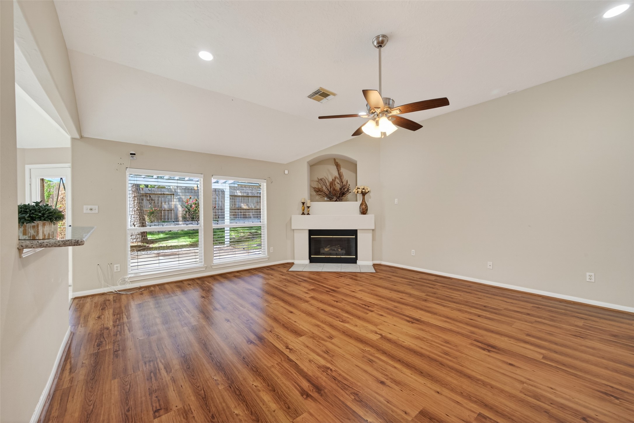 23211 Goldensong Court Spring, TX 77373 - Photo 9 of 46 a view of a livingroom with a fireplace a chandelier and wooden floor