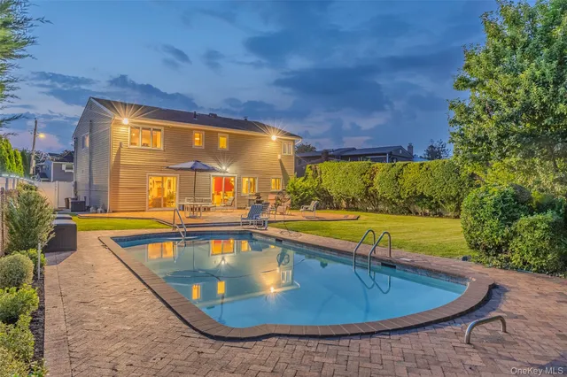 swimming pool view with a seating space