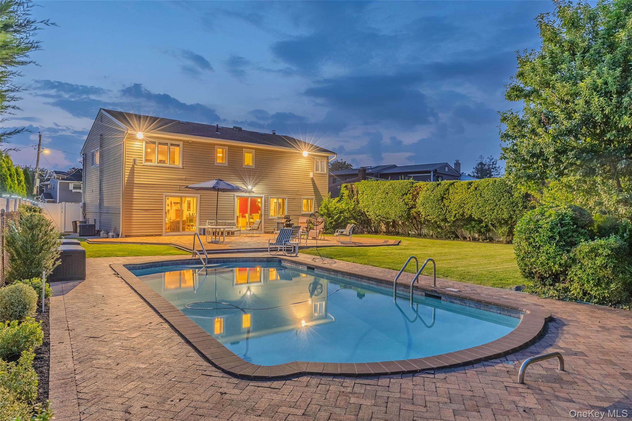 swimming pool view with a seating space