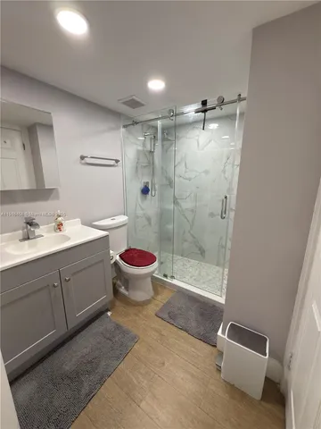 a bathroom with a double vanity sink toilet and shower