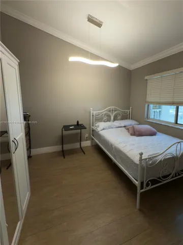 a bedroom with a bed and a chair