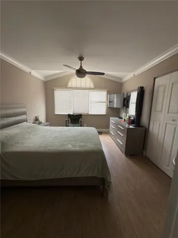 a bedroom with a bed dresser and a window