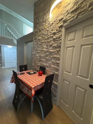 a dining room with furniture and window