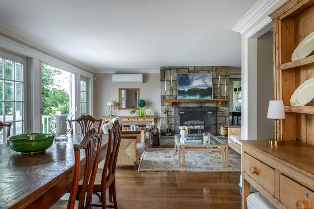 a living room with furniture a fireplace and a large window