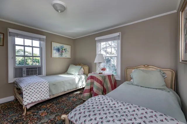 a bedroom with two beds and a window