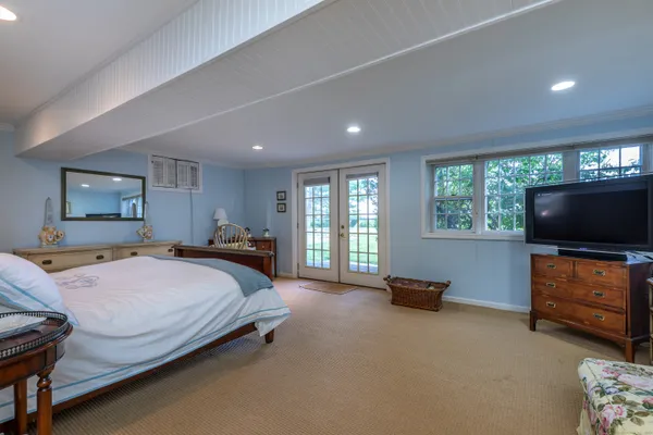 a bed room with a bed and a television