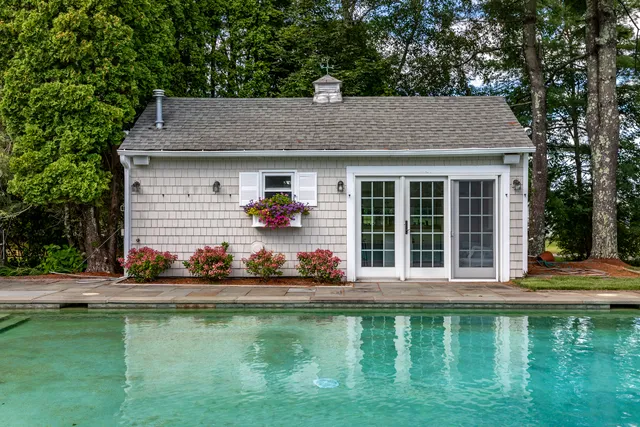 a house with swimming pool in front of it