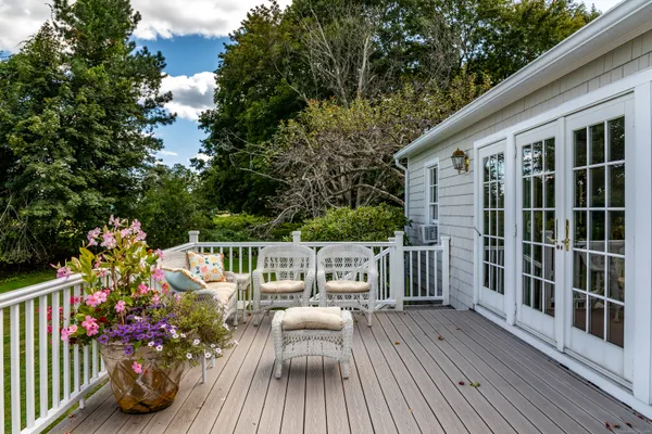 a view of balcony with seating space and wooden floor